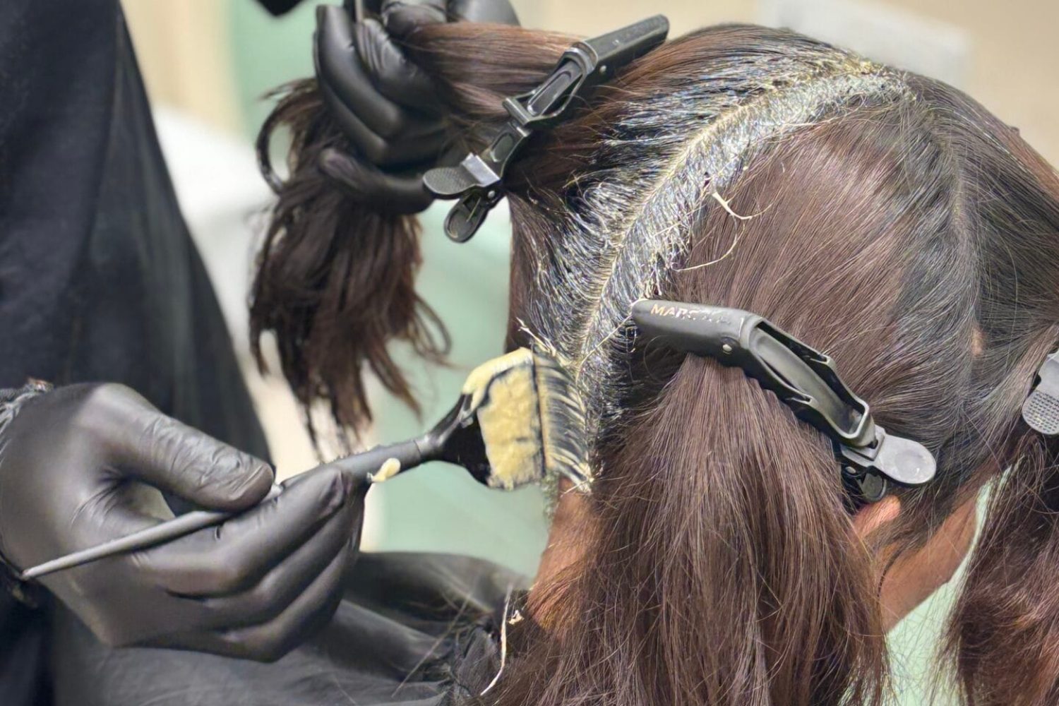 This is the picture of Iconik Salon where hair colouring is being applied to a female.